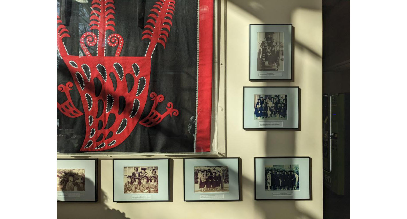 Photograph of FNHL graduation photographs hung on a wall.